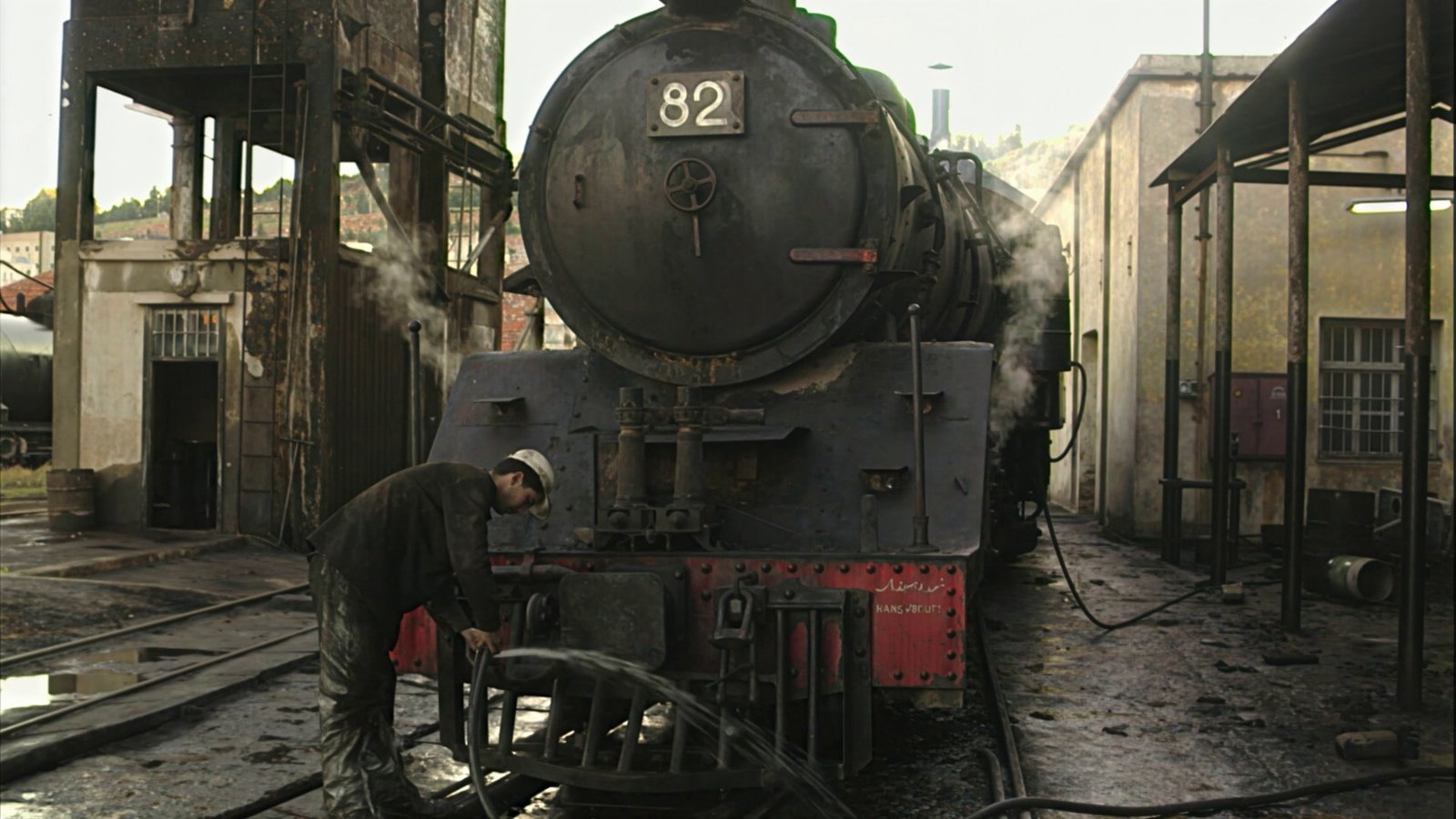 Restored close view of steam locomotive wheels and steam